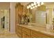 Bathroom with custom vanity, ample storage, and bright lighting at 16716 S 32Nd Ln, Phoenix, AZ 85045