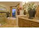 Bathroom with jetted tub and walk-in shower, granite countertop, and decorative flowers at 16716 S 32Nd Ln, Phoenix, AZ 85045
