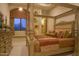 Comfortable bedroom with a four-poster bed, cozy bedding, and views to the desert beyond creates a relaxing retreat at 16716 S 32Nd Ln, Phoenix, AZ 85045