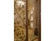 A decorative metal gate leads to an entryway with custom stonework and shelving at 16716 S 32Nd Ln, Phoenix, AZ 85045