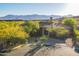 Desert home with mature landscaping, circular driveway, and mountain views at 16716 S 32Nd Ln, Phoenix, AZ 85045
