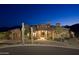 Stunning desert home with stone accents, lush landscaping, and mountain views at twilight at 16716 S 32Nd Ln, Phoenix, AZ 85045