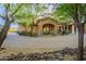 Beautiful home showcasing stone accents, a charming entryway, and a circular paver driveway at 16716 S 32Nd Ln, Phoenix, AZ 85045