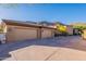 Spacious three-car garage with ample parking space and exterior lighting, set against a mountain backdrop at 16716 S 32Nd Ln, Phoenix, AZ 85045