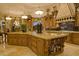 Kitchen features a large center island with granite countertops and custom wood cabinets at 16716 S 32Nd Ln, Phoenix, AZ 85045