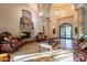 Ornate living room featuring stone columns, a fireplace, and decorative flooring at 16716 S 32Nd Ln, Phoenix, AZ 85045