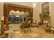 Cozy living room featuring a stone fireplace, large windows, and elegant decor at 16716 S 32Nd Ln, Phoenix, AZ 85045