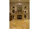 A cozy fireplace is surrounded by custom shelving and marble accents at 16716 S 32Nd Ln, Phoenix, AZ 85045