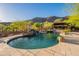 A backyard swimming pool with a rock waterfall and mountain views at 16716 S 32Nd Ln, Phoenix, AZ 85045