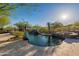 A backyard pool featuring desert landscaping and a tanning ledge at 16716 S 32Nd Ln, Phoenix, AZ 85045
