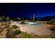 Backyard desert landscaping with pool, spa, and fire pit at night at 16716 S 32Nd Ln, Phoenix, AZ 85045
