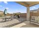Covered patio with comfortable seating, outdoor grill, and paved flooring at 1749 W Posada St, Coolidge, AZ 85128