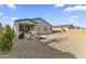 Backyard featuring a patio, grill, hammock, and desert landscaping at 1749 W Posada St, Coolidge, AZ 85128