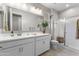 Bathroom featuring a double sink vanity and a glass-enclosed shower at 1749 W Posada St, Coolidge, AZ 85128
