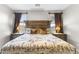 Bedroom with a large decorative bed, side tables and lamps at 1749 W Posada St, Coolidge, AZ 85128