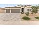 Charming single-story home boasts a neutral color palette, three-car garage, and beautiful desert landscaping at 1749 W Posada St, Coolidge, AZ 85128