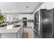 Well-lit kitchen features white cabinetry, modern appliances, a spacious island, and seamless flow to a dining area at 1749 W Posada St, Coolidge, AZ 85128