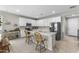 Open kitchen featuring white cabinetry, a black stainless-steel refrigerator, and an island with seating at 1749 W Posada St, Coolidge, AZ 85128