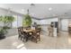 Bright kitchen with white cabinets, modern appliances, and dining table at 1749 W Posada St, Coolidge, AZ 85128