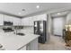 Bright kitchen featuring white cabinets, stainless steel appliances, and a center island with bar seating at 1749 W Posada St, Coolidge, AZ 85128