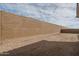Unlandscaped backyard featuring dirt and a tall block wall at 18564 W Cathedral Rock Dr, Goodyear, AZ 85338