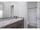Bathroom features modern vanity with white countertop and gray cabinets at 18564 W Cathedral Rock Dr, Goodyear, AZ 85338
