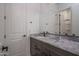 Bathroom with modern vanity featuring white countertop and gray cabinets at 18564 W Cathedral Rock Dr, Goodyear, AZ 85338