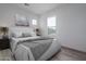 Bright bedroom featuring a large window, wood-look tile flooring, and neutral walls at 18564 W Cathedral Rock Dr, Goodyear, AZ 85338
