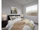 Cozy bedroom features a large window, wood-look tile flooring, and neutral walls at 18564 W Cathedral Rock Dr, Goodyear, AZ 85338