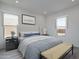 Cozy bedroom features wood-look flooring, neutral colors, and comfortable furnishings at 18564 W Cathedral Rock Dr, Goodyear, AZ 85338