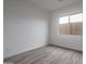 Simple bedroom featuring wood-look tile flooring and a window at 18564 W Cathedral Rock Dr, Goodyear, AZ 85338