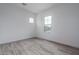 Neutral bedroom featuring light walls, tile floors, and two windows at 18564 W Cathedral Rock Dr, Goodyear, AZ 85338