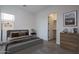 Comfortable bedroom features neutral walls, wood-look tile flooring, and a walk-in closet at 18564 W Cathedral Rock Dr, Goodyear, AZ 85338
