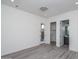 Neutral bedroom boasts wood-look tile floor, walk-in closet, and ensuite bathroom at 18564 W Cathedral Rock Dr, Goodyear, AZ 85338