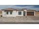 Charming single-story home with a terracotta tile roof, desert landscaping, and a two-car garage at 18564 W Cathedral Rock Dr, Goodyear, AZ 85338