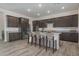 Bright kitchen with stainless steel appliances, dark wood cabinets, and a spacious island with bar stool seating at 18564 W Cathedral Rock Dr, Goodyear, AZ 85338