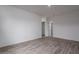Spacious room featuring wood-look tile flooring and white walls at 18564 W Cathedral Rock Dr, Goodyear, AZ 85338