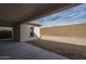 Covered patio featuring bare cement and partial view of the unlandscaped backyard and house exterior at 18564 W Cathedral Rock Dr, Goodyear, AZ 85338