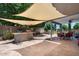 Spacious backyard patio with a built-in bar, grill, and shaded seating area, ideal for outdoor entertaining at 1870 E Oakland St, Gilbert, AZ 85295