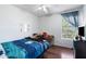 Inviting bedroom with a ceiling fan and large window, offering natural light and comfortable space at 1870 E Oakland St, Gilbert, AZ 85295