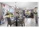 Inviting dining area featuring a glass table, chandelier, and large windows with view to the exterior at 1870 E Oakland St, Gilbert, AZ 85295