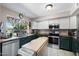 Well-lit kitchen featuring modern appliances, green cabinets, and tile floors, perfect for culinary enthusiasts at 1870 E Oakland St, Gilbert, AZ 85295