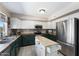 Modern kitchen with stainless steel appliances, butcher block island, and white upper cabinets for ample storage at 1870 E Oakland St, Gilbert, AZ 85295