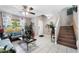 Bright living room with tile flooring, a comfortable sofa, and floral curtains, offering a cozy and inviting space at 1870 E Oakland St, Gilbert, AZ 85295