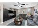 Inviting living room with a large TV, comfortable seating, and tile flooring, ideal for relaxation and entertainment at 1870 E Oakland St, Gilbert, AZ 85295