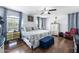 Spacious main bedroom with hardwood floors, a ceiling fan, and large windows providing plenty of natural light at 1870 E Oakland St, Gilbert, AZ 85295