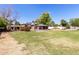 Wide angle of the backyard featuring grass, gazebos, and drought resistant landscaping at 2043 E Quartz St, Mesa, AZ 85213