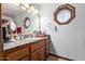 Bathroom features a large mirror, granite counters, unique lighting, and tile flooring at 2043 E Quartz St, Mesa, AZ 85213
