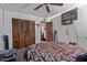 Cozy bedroom boasts ceiling fan and a large dresser with decorative items at 2043 E Quartz St, Mesa, AZ 85213