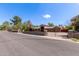 Gated single-story home with brick facade, mature trees, and a neatly maintained landscape at 2043 E Quartz St, Mesa, AZ 85213